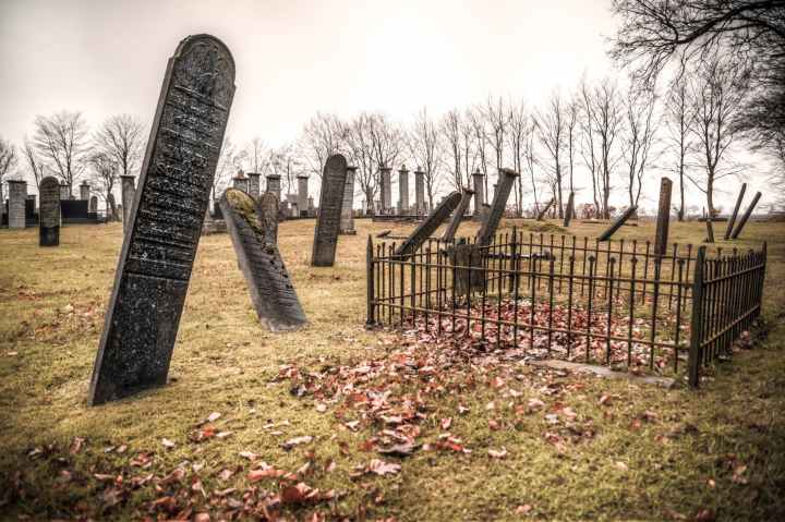 photography of graveyard under cloudy sky
