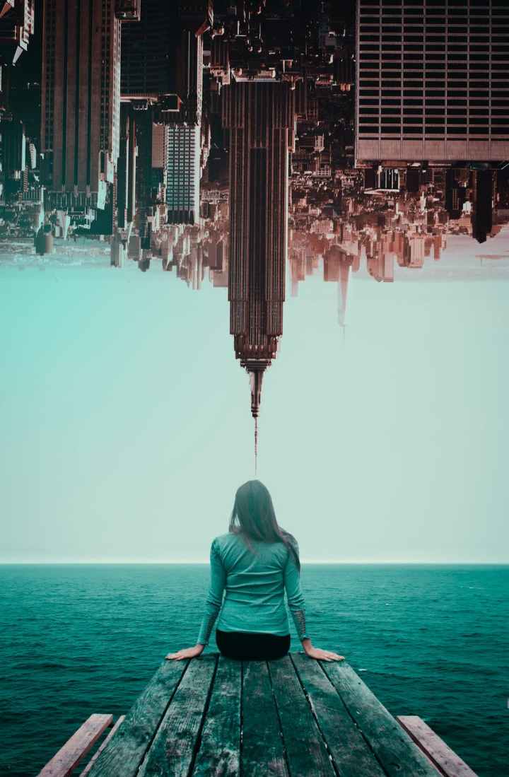 photo of woman and inverted buildings